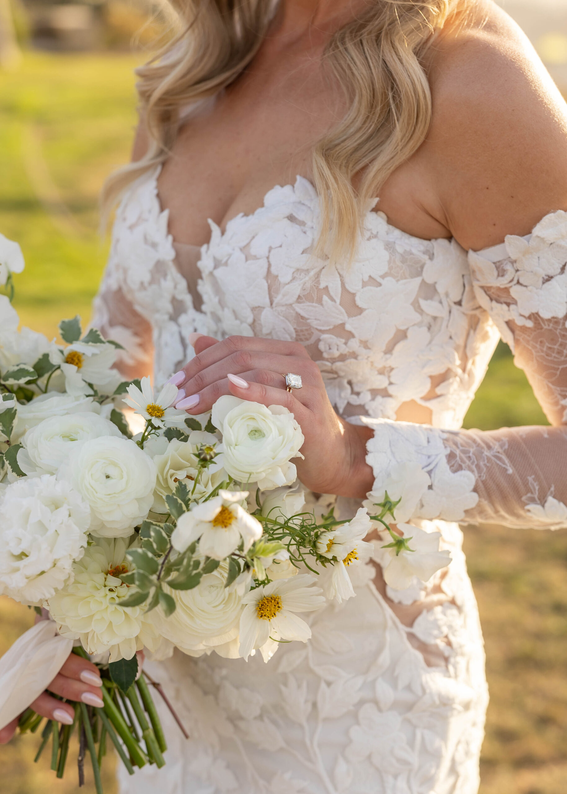 Modern wedding portraits with ocean backdrop and classic florals