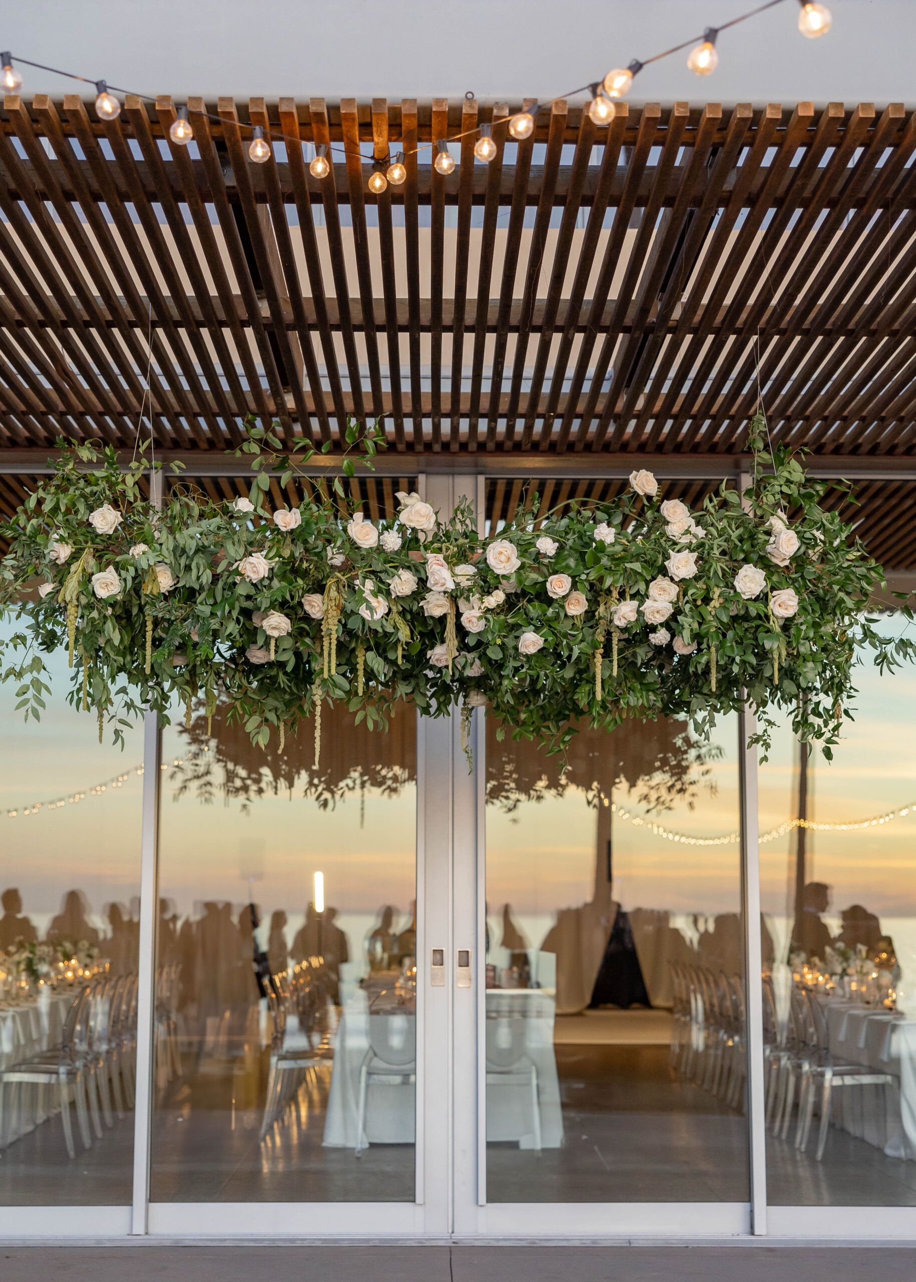 Elegant tablescape with candles, white linens, and Crown Rentals chairs