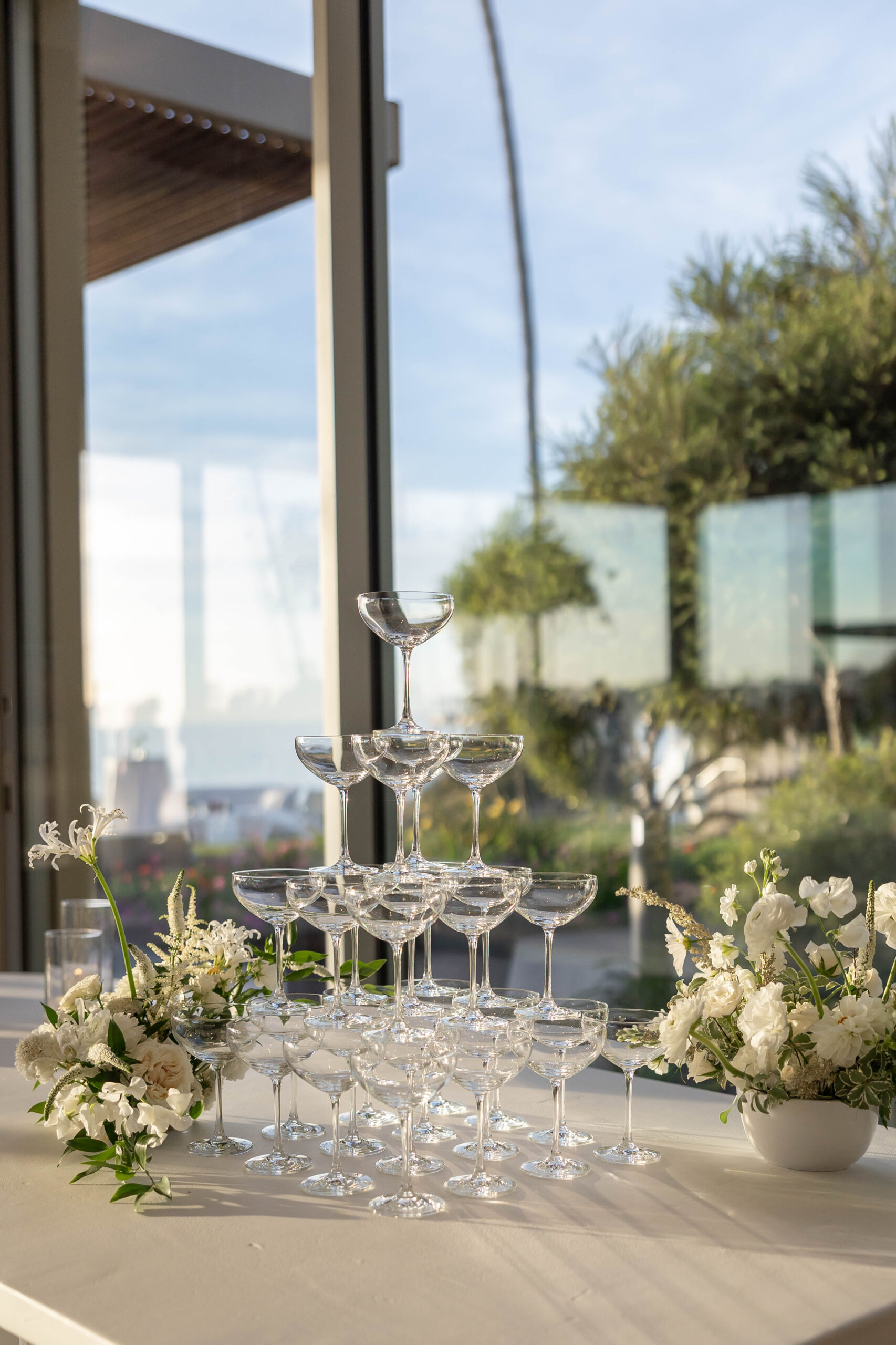 Elegant tablescape with candles, white linens, and Crown Rentals chairs