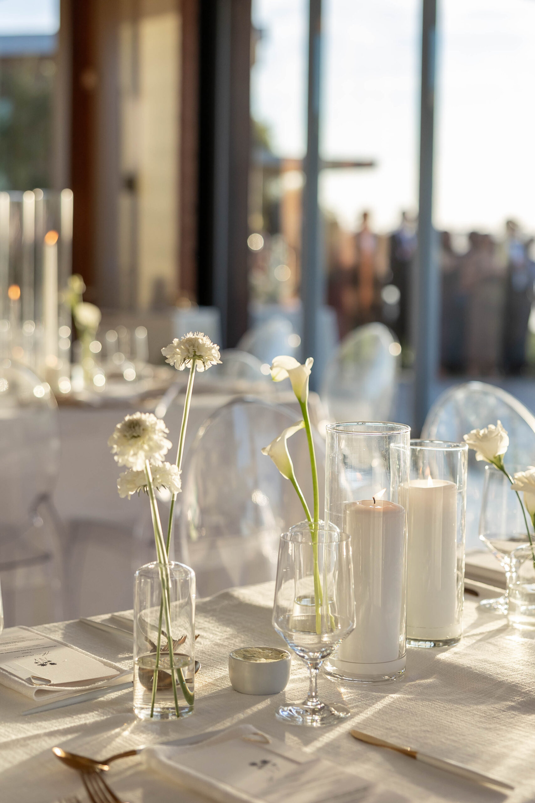 Elegant tablescape with candles, white linens, and Crown Rentals chairs