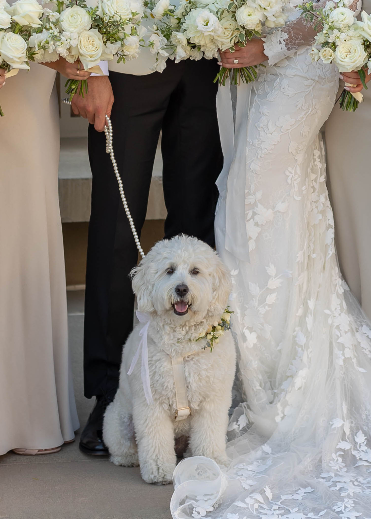 Modern wedding portraits with ocean backdrop and classic florals