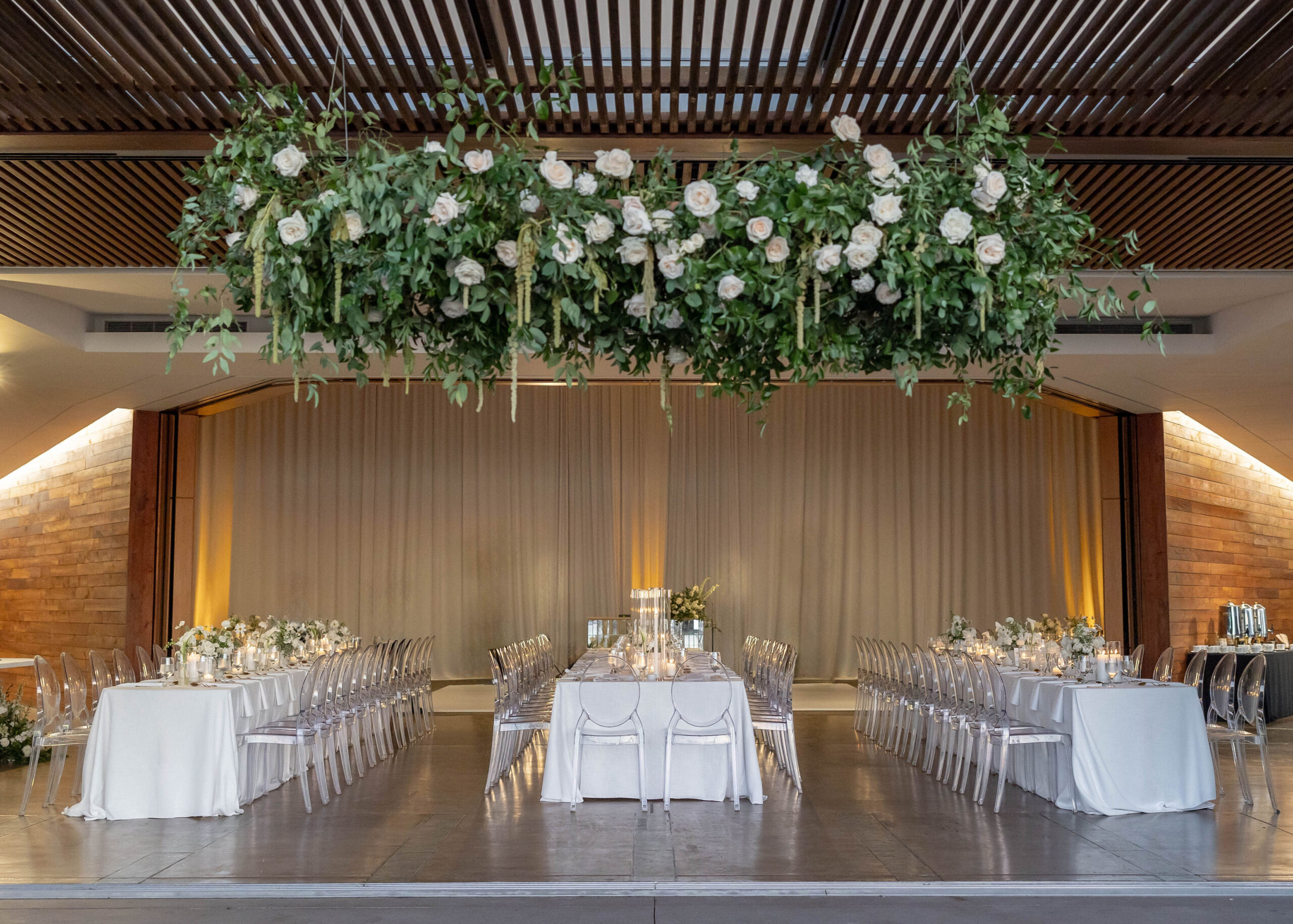 White flower ceiling installation welcoming guests into reception space