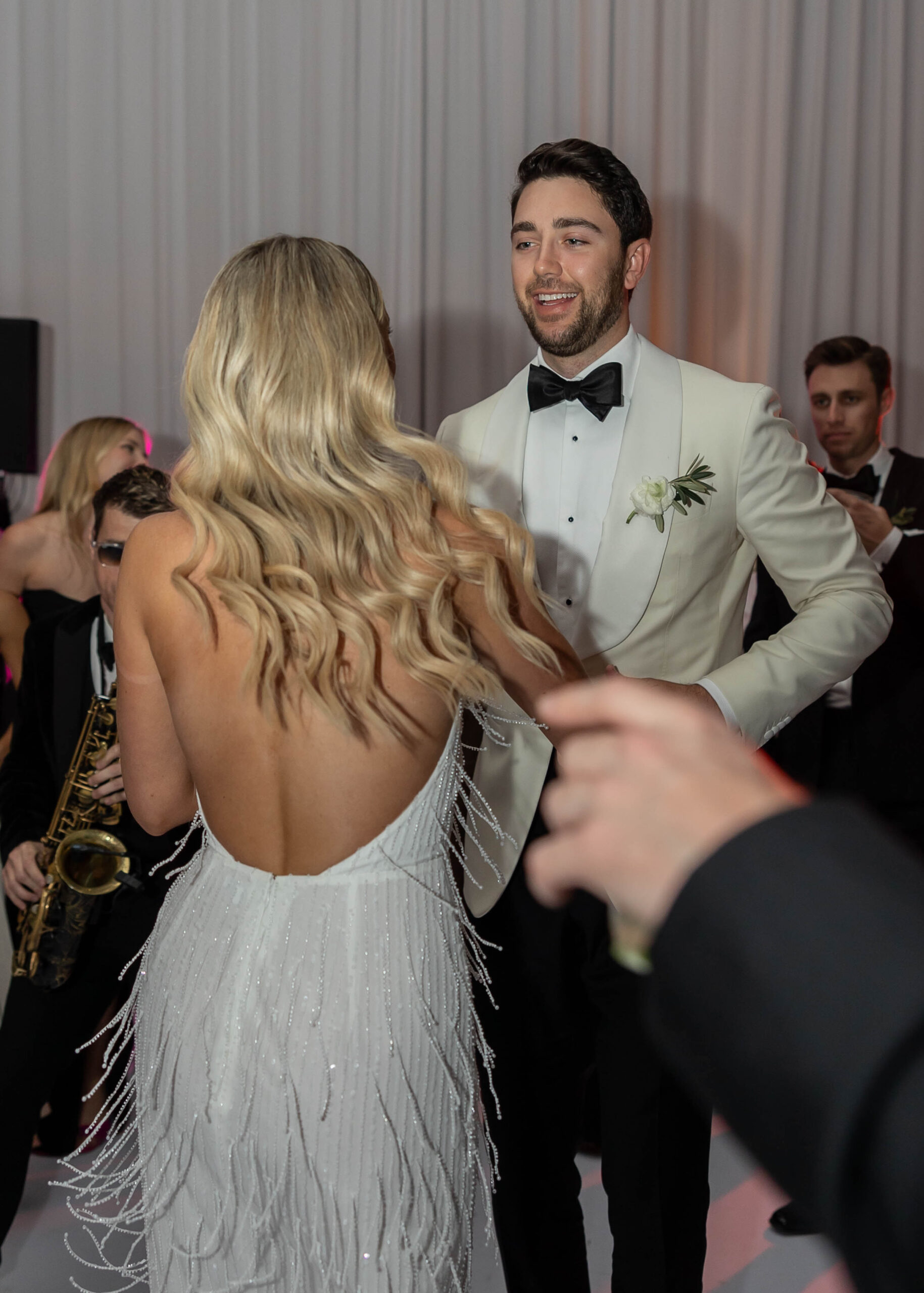 Bride’s second look with beaded party dress and saxophone grand entrance