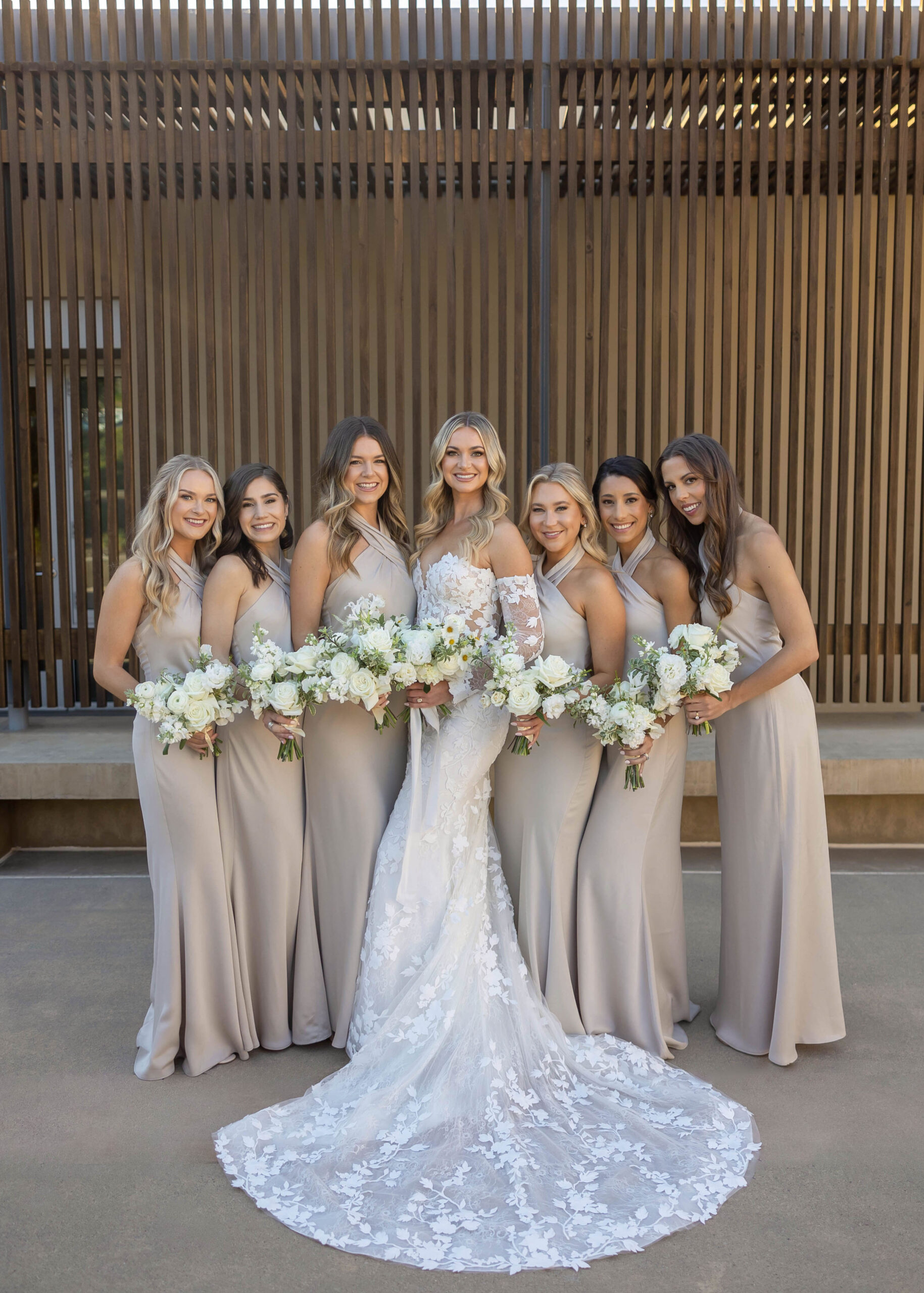 Modern wedding portraits with ocean backdrop and classic florals