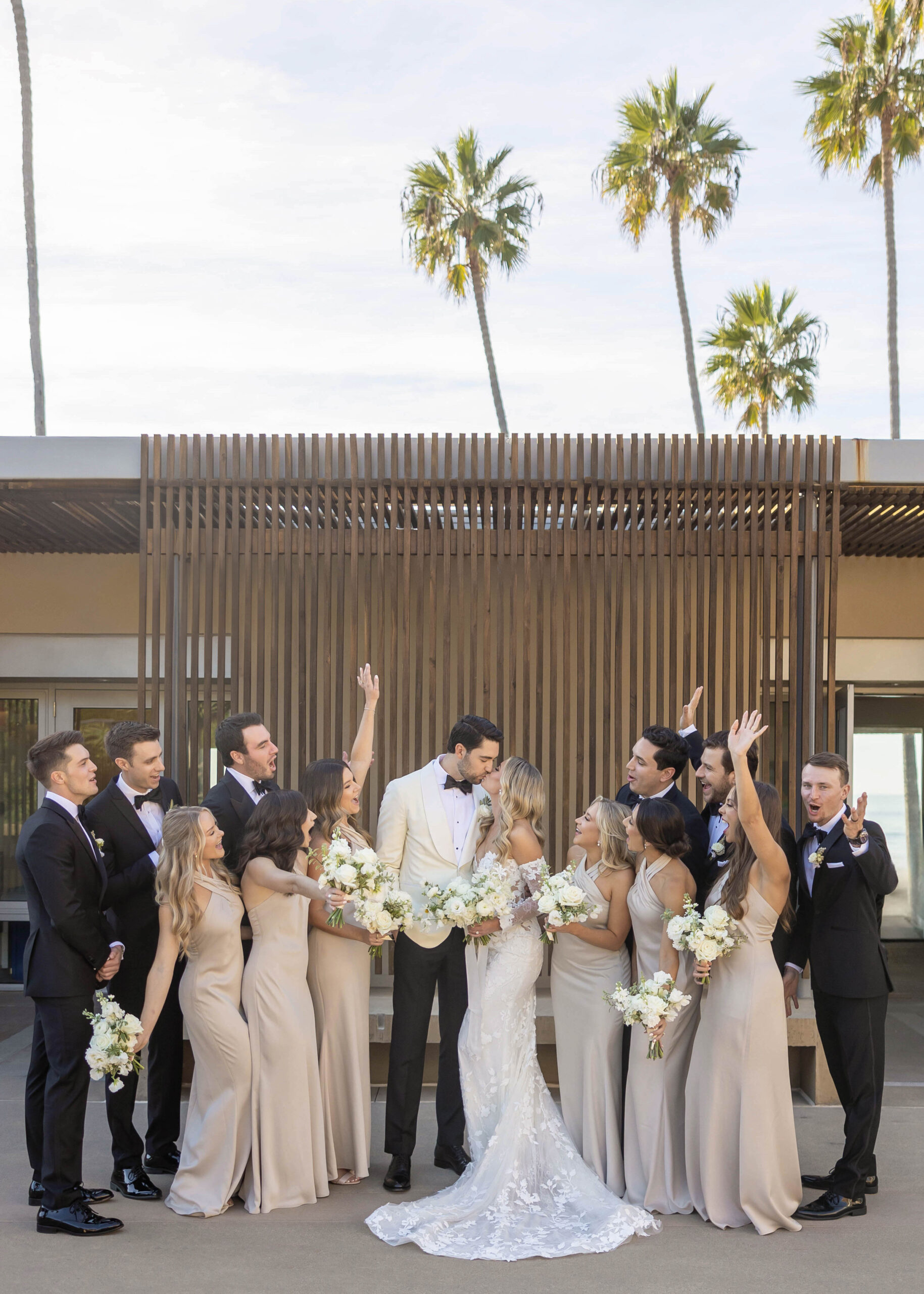 Modern wedding portraits with ocean backdrop and classic florals