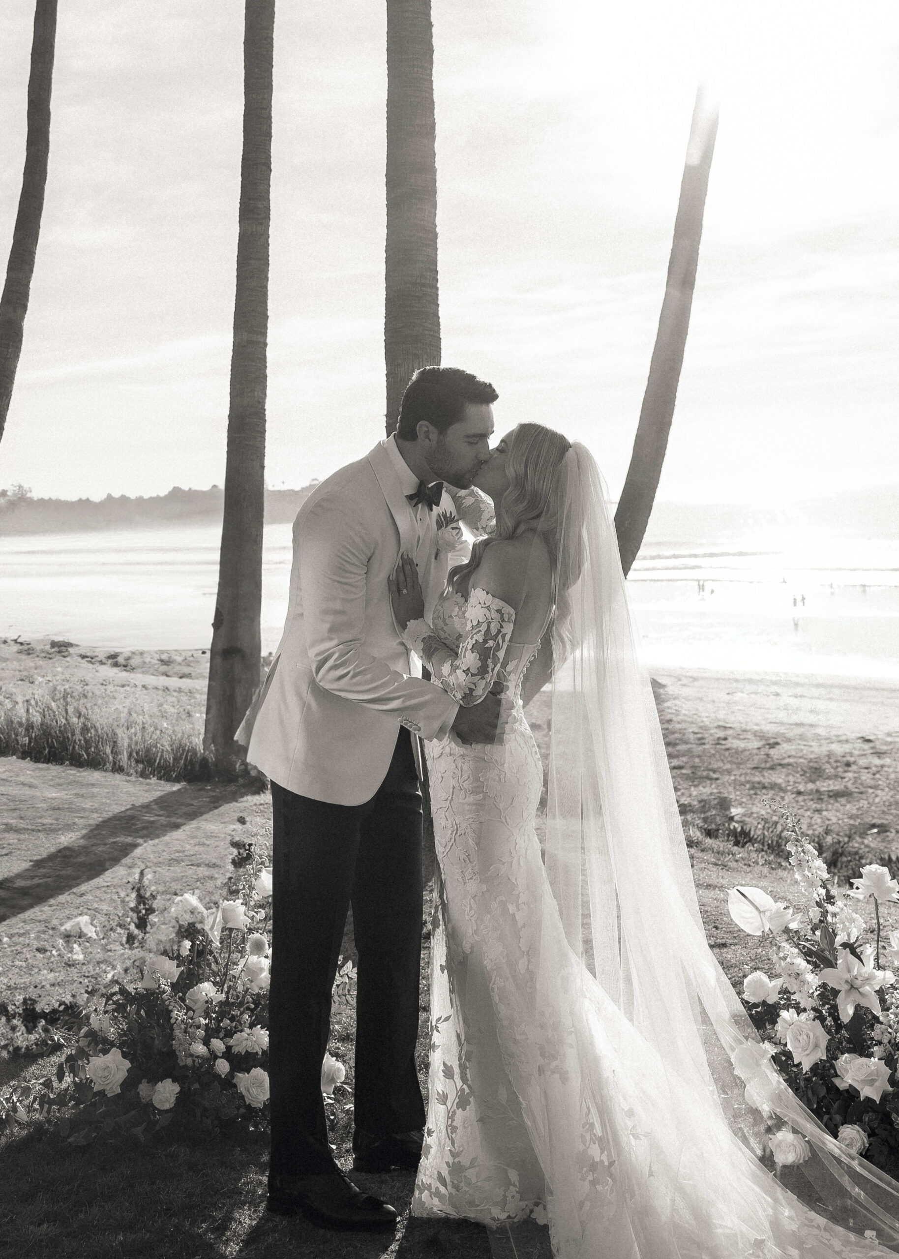 Romantic vows with coastal view and candle-lined aisle