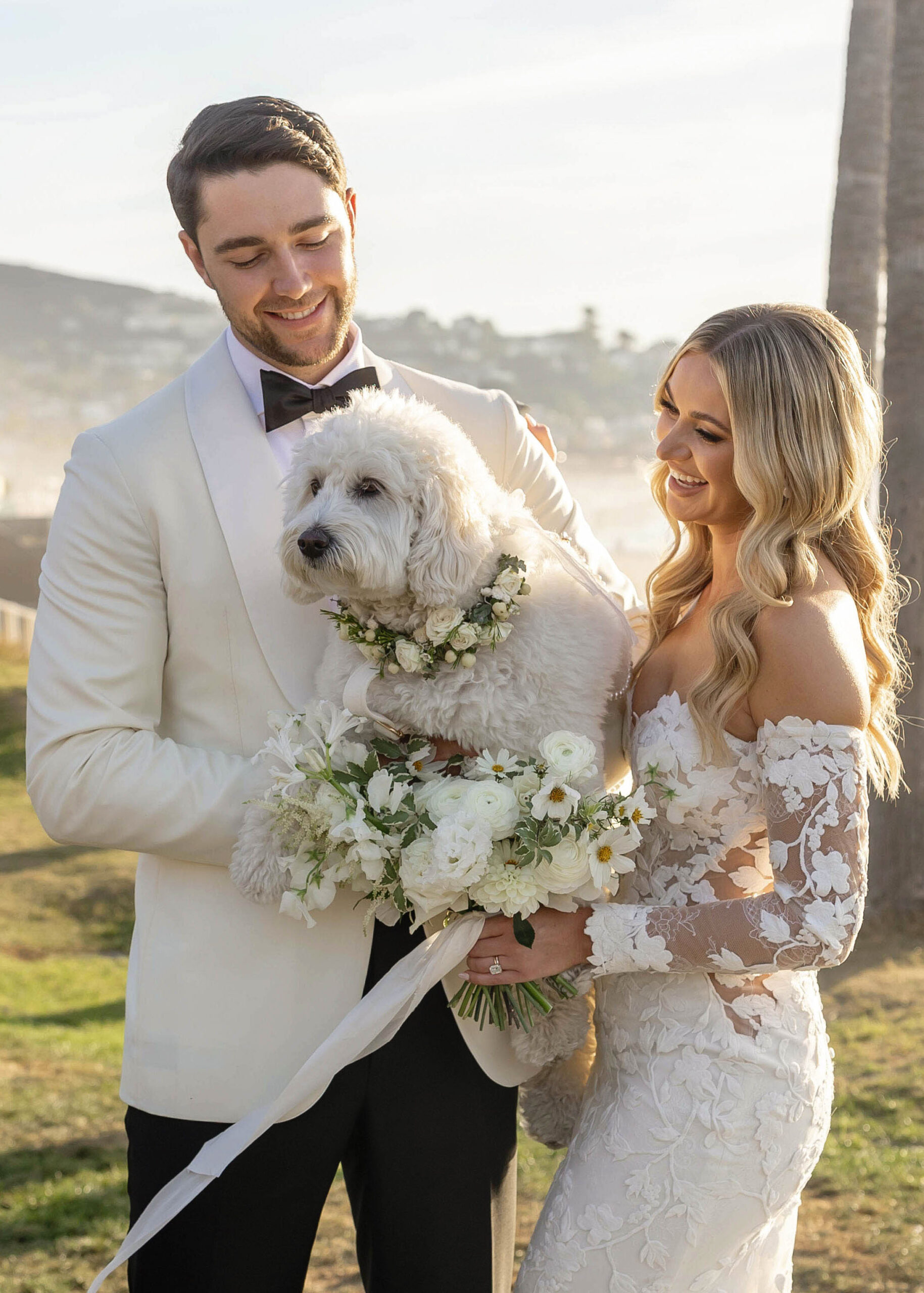 Modern wedding portraits with ocean backdrop and classic florals