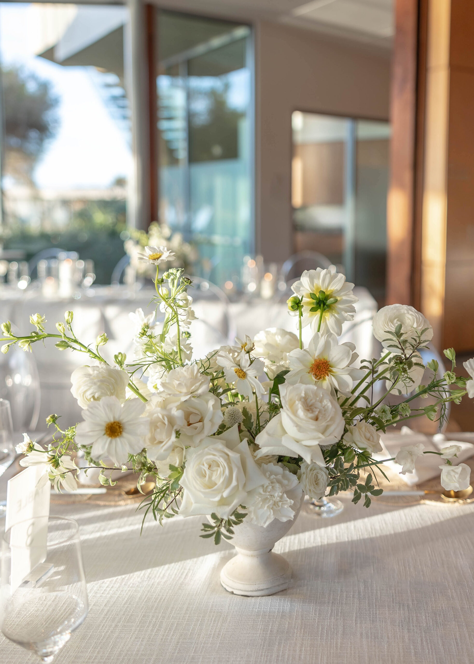 Elegant tablescape with candles, white linens, and Crown Rentals chairs